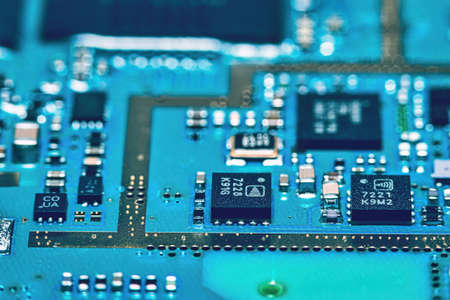 Microchips integrated on the board. The microcircuit photographed in close-up.