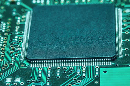 Microchips integrated on the board. The microcircuit photographed in close-up.の写真素材