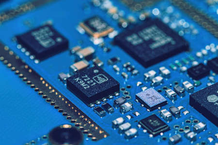 Microchips integrated on the board. The microcircuit photographed in close-up.の写真素材