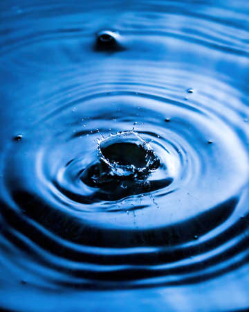 Splashes of water and blurry waves on it.の写真素材