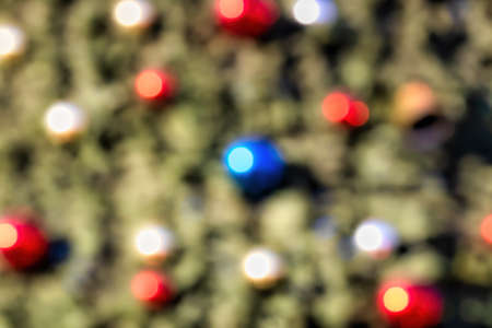 Blured background with christmas toys and balls on an artificial spruce. Xmas decoration.