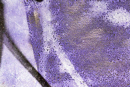 A fragment of colorful graffiti painted on a wall. Abstract urban background for design.