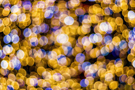 Christmas lights blured background. Light bokeh from Xmas decoration. Abstract holiday backdrop.