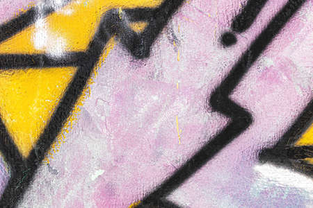 A fragment of colorful graffiti painted on a wall. Abstract urban background for design.の写真素材