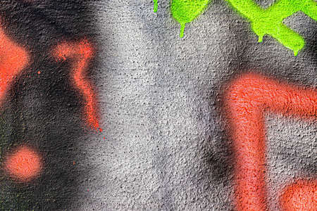 A fragment of colorful graffiti painted on a wall. Abstract urban background for design.