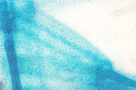 A fragment of colorful graffiti painted on a wall. Abstract urban background for design.
