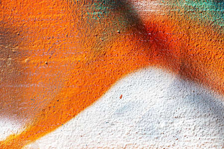 A fragment of colorful graffiti painted on a wall. Abstract urban background for design.の写真素材