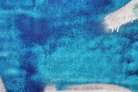 A fragment of colorful graffiti painted on a wall. Abstract urban background for design.