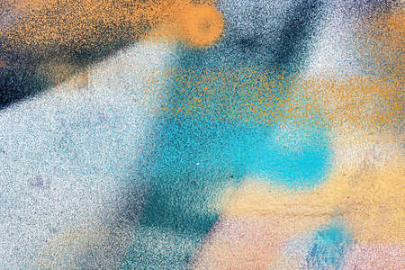 A fragment of colorful graffiti painted on a wall. Abstract urban background for design.の写真素材