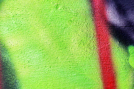 A fragment of colorful graffiti painted on a wall. Abstract urban background for design.の写真素材