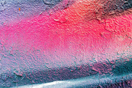 A fragment of colorful graffiti painted on a wall. Abstract urban background for design.