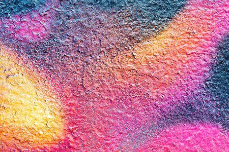 A fragment of colorful graffiti painted on a wall. Abstract urban background for design.の写真素材