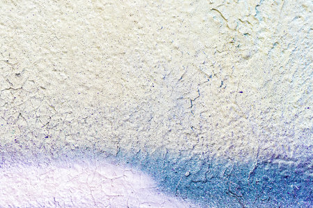 A fragment of colorful graffiti painted on a wall. Abstract urban background for design.の写真素材