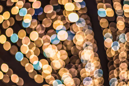 Christmas lights blured background. Light bokeh from Xmas decoration. Abstract holiday backdrop.の写真素材