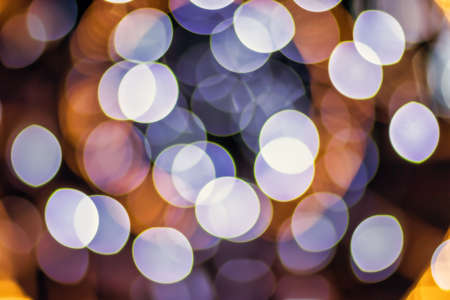Christmas lights blured background. Light bokeh from Xmas decoration. Abstract holiday backdrop.の写真素材