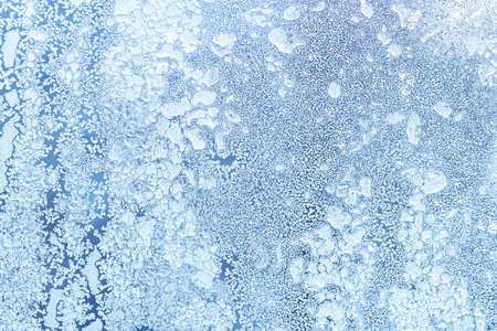 The texture of the glass covered with frost in winter in cold weather. Abstract natural background.の写真素材