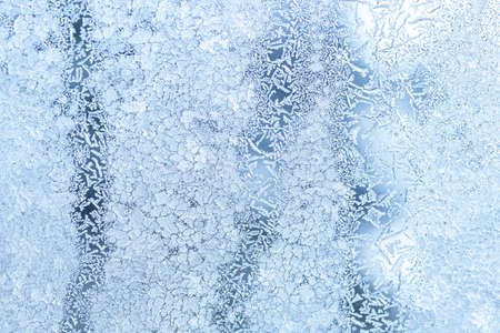The texture of the glass covered with frost in winter in cold weather. Abstract natural background.の写真素材