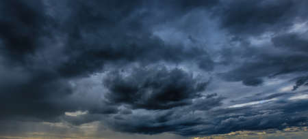 Dark storm clouds in autumn. An impending storm, hurricane or thunderstorm. Bad extrime weather.の写真素材