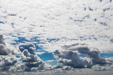 A sky with dramatic cumulus clouds on a sunny day.