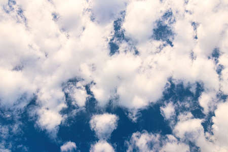 A sky with dramatic cumulus clouds on a sunny day.の写真素材
