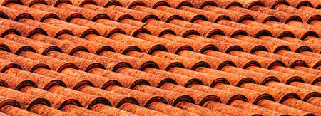 Texture of red clay roof tiles. Abstract background for design.