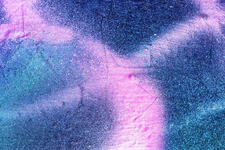 A fragment of colorful graffiti painted on a wall. Abstract urban background for design.の写真素材