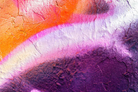 A fragment of colorful graffiti painted on a wall. Abstract urban background for design.の写真素材
