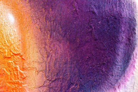 A fragment of colorful graffiti painted on a wall. Abstract urban background for design.