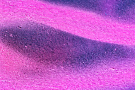 A fragment of colorful graffiti painted on a wall. Abstract urban background for design.の写真素材