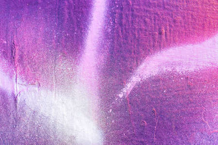 A fragment of colorful graffiti painted on a wall. Abstract urban background for design.