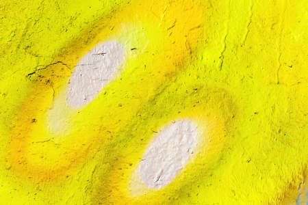 A fragment of colorful graffiti painted on a wall. Abstract urban background for design.