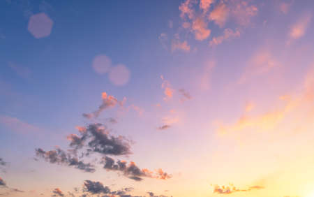 Dramatic cloudy sky at sunset or sunrise. The sun's rays breaking through the clouds.