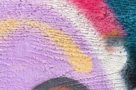A fragment of colorful graffiti painted on a wall. Abstract urban background for design.の写真素材