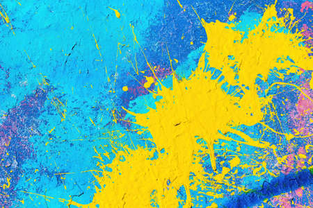 A fragment of colorful graffiti painted on a wall. Abstract urban background for design.の写真素材