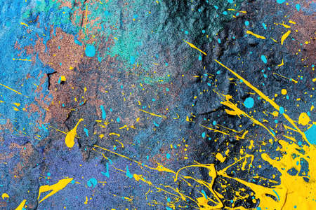 A fragment of colorful graffiti painted on a wall. Abstract urban background for design.