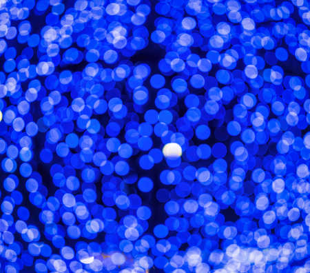 Christmas lights blured background. Light bokeh from Xmas decoration. Abstract holiday backdrop.の写真素材