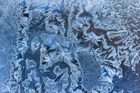 Frost texture on frozen glass in winter. Winter background.
