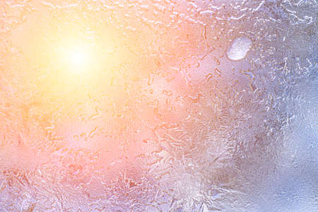Frost texture on frozen glass illuminated by the sun in winter. Winter background.