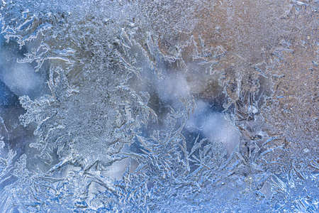 Frost texture on frozen glass in winter. Winter background.