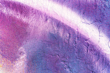 A fragment of colorful graffiti painted on a wall. Abstract urban background for design.