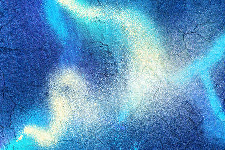 A fragment of colorful graffiti painted on a wall. Abstract urban background for design.