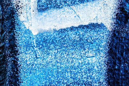 A fragment of colorful graffiti painted on a wall. Abstract urban background for design.