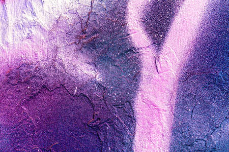 A fragment of colorful graffiti painted on a wall. Abstract urban background for design.