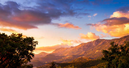 Sunset on the Adriatic coast near the city of Budva, Montenegro. View of the city and rocks.