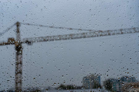 Raindrops on glass in cloudy rainy weather. Autumn bad weather concept.の写真素材
