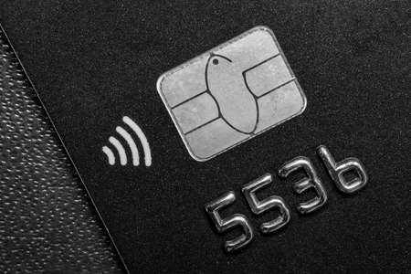 Close-up shot of a debit or credit plastic card with a chip.