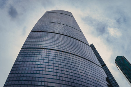 RUSSIA, MOSCOW - JULY 17, 2022: Low angle view of Moscow-City skyscrapers. New business and finance district in Moscow downtown. Tops of modern corporate buildings against the cloudy sky.のeditorial素材