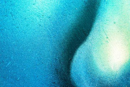 A fragment of colorful graffiti painted on a wall. Abstract urban background for design. spray...