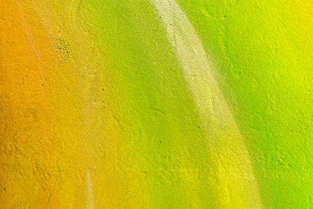 A fragment of colorful graffiti painted on a wall. Abstract urban background for design. spray painting art.の写真素材