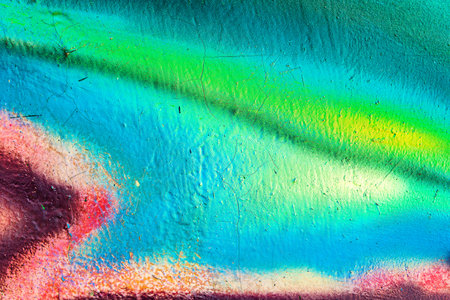 A fragment of colorful graffiti painted on a wall. Abstract urban background for design. spray painting art.の写真素材